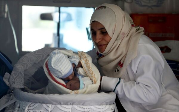 Medicīnas māsa ar Siāmas dvīņiem ātrās palīdzības mašīnā Sanas lidostā, Jemenā - Sputnik Latvija