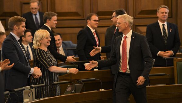 Юта Стрике и Кришьянис Кариньш собираются пожать руки, радуясь принятию бюджета - Sputnik Латвия