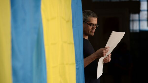 Избиратель во время голосования на выборах в Киеве - Sputnik Латвия
